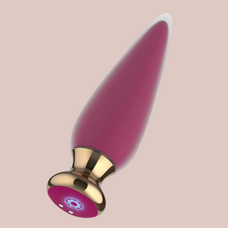 The Pink App Controlled Vibrator shown in full length, you can see the base where the charger attaches.