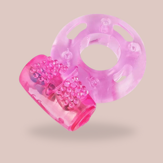 An angled view of the cock ring and clitoral stimulator, the ring can be stretched to fit and the clitoral stimulator has a raised butterfly design.