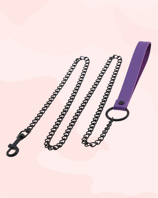 Purple leather lead with black chain on a light pink background