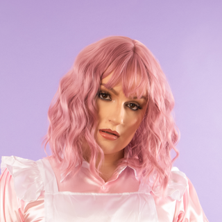 A side view of the raspberry wave shoulder length wig from House of Chastity. It has a cute wave and fringe style.