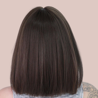 HOC31112 Brown Sleek Length Hair. This is a dark brown wig that has been styled into a sleek bob style and is designed to brush the shoulders. It also has a face softeningly blunt fringe. View of the rear of the wig illustrating the straight cut.