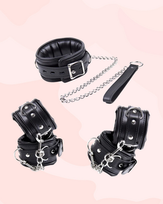 Showing the collar, lead, wrist and ankle cuffs for the Nightfall Bondage set on a pink background.