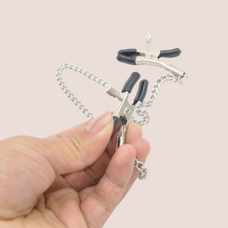 A close up of the nipple clamps, you can see the press open clamps and the fixable screw