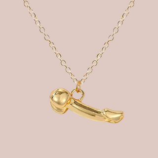 Showing the gold chain and the penis shaped pendant, from this angle you can see the balls and penis.
