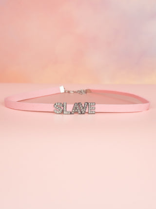 The Slave necklace is sown on a flat surface.