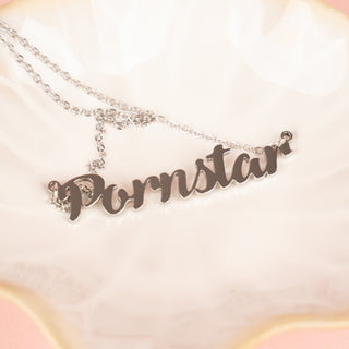 The Pornstar necklace shown  in silver, you can see the pendant lettering close up.