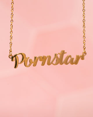 A close up picture of the pornstar necklace in gold.