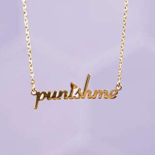 Elegant gold 'Punish Me' necklace featuring a delicate chain and a sleek, polished pendant with bold lettering