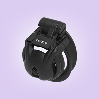 A side view of the Python Nub chastity cage from House Of Chastity, it is fully assembled into its double cuff style base ring and the integral lock is fixed in place.