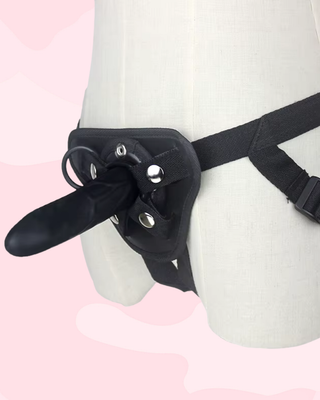 An angled view of the small Smooth Strap On Dildo fitted to the waist strap.