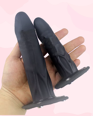 The two sizes of dildo being held to show the size difference.