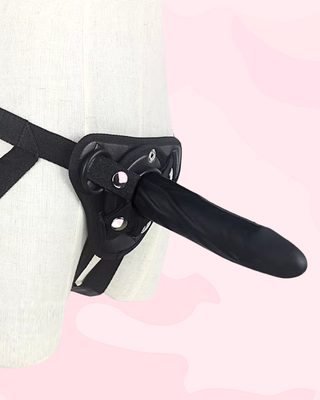 An angled view of the large Smooth Strap On Dildo fitted into the waist strap.