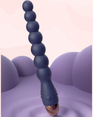 Blue 10 speed vibrator with a rose gold end on a pink background