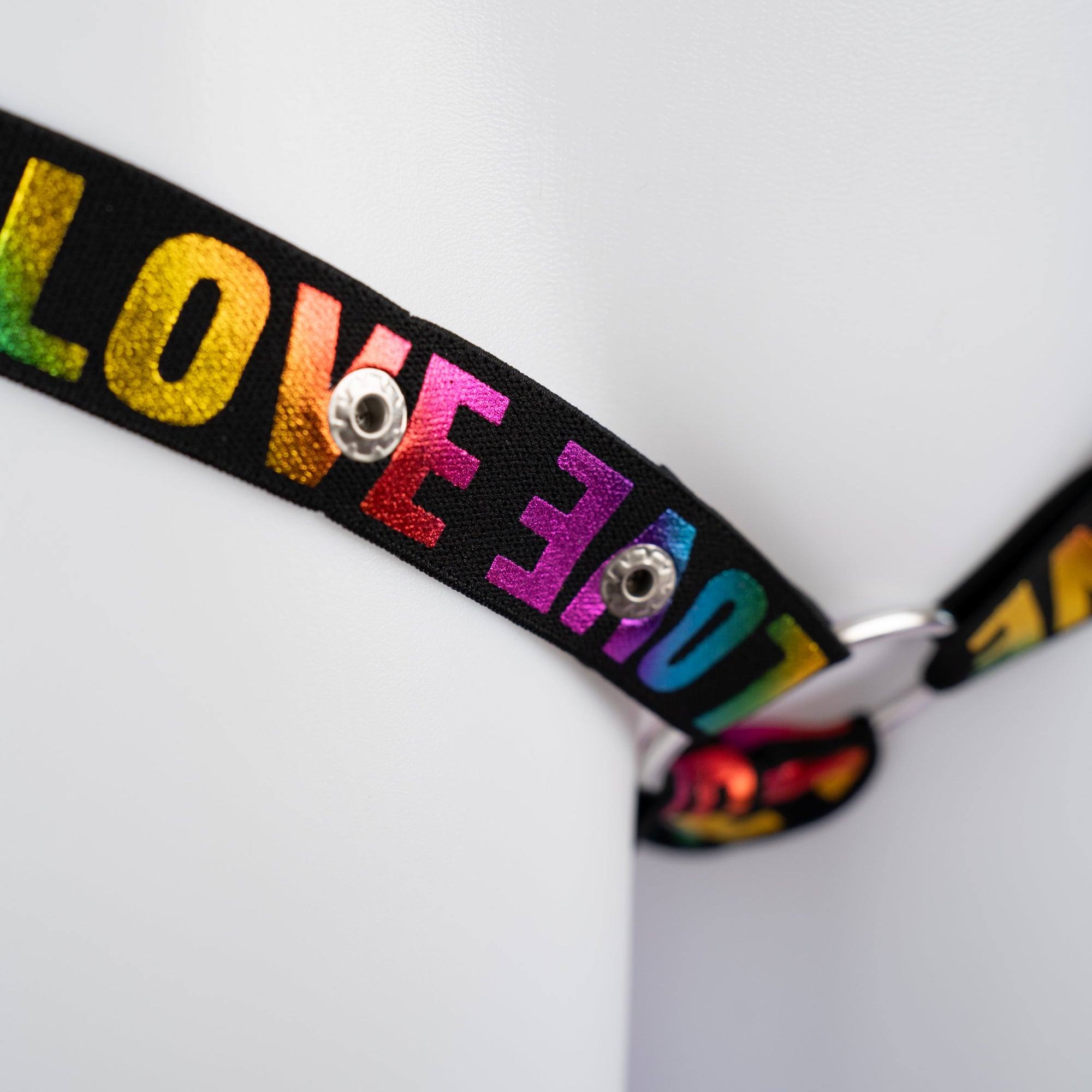 A close up of the shiny multi-colour print on the chastity belt.