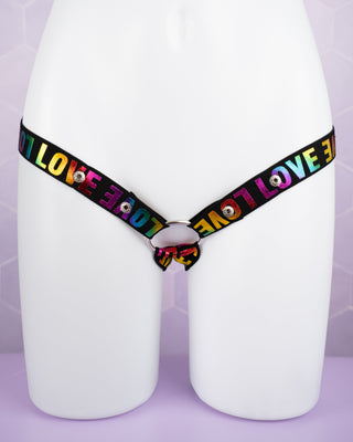close up of the rainbow coloured 3 way restraining chastity belt
