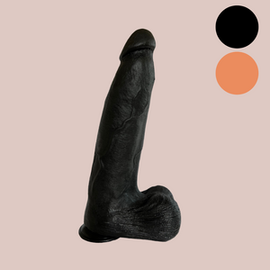 This is a super sized dildo, it is shown here standing on its suction base, you can see the realistic balls, veining and head. This image also shows the two colours that this dildo is avaialbe in, black and flesh.