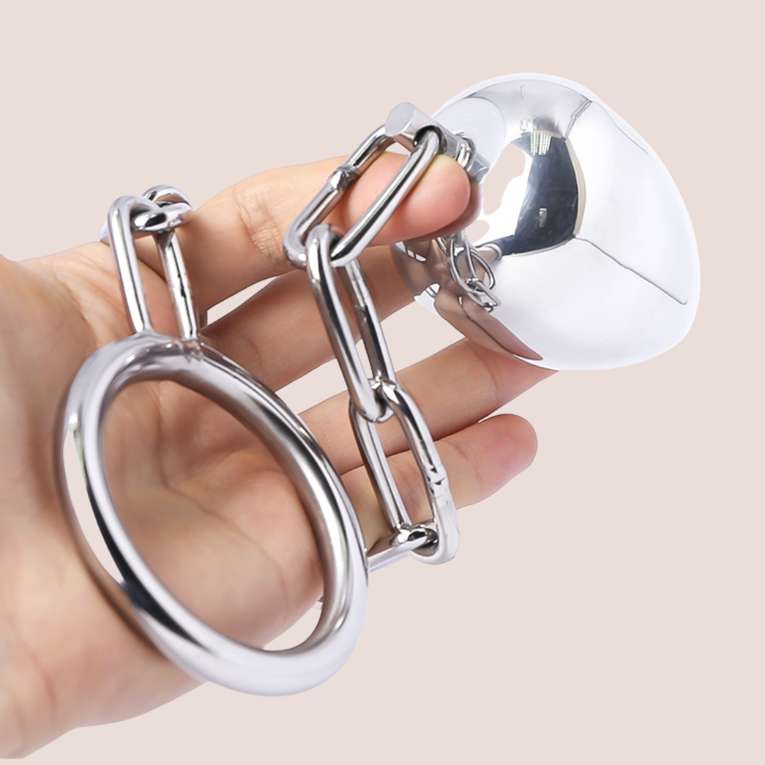The Anal Egg With Chained Cock Ring wrapped around a hand, this gives a good idea of the length of chain provided and the thickness of the product.