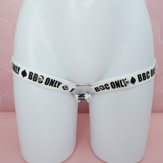 A front on view of the BBC Only chastity belt, the white belt with black repeated logo is shown on a model.