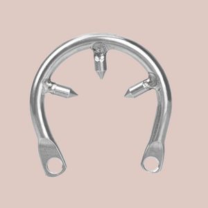 The metal barbed ring, shown with the 3 spikes that deny the wearer to remove their chastity cage when worn with their chastity device.