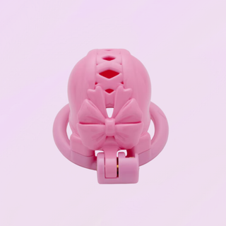 the chastity cage is shown sitting on its base ring, the pink cage and base ring are fixed to each other