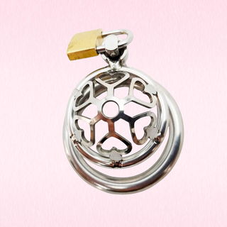 The Cage Of Hearts Chastity Cage with external padlock on a pale pink background.