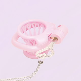 The silver Captivate Key is shown placing the lock into The Vessel chastity cage