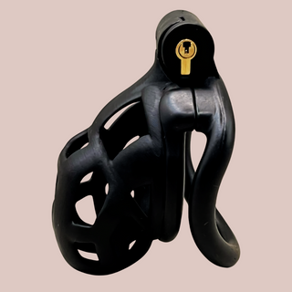 A side view of the Cobra Curved Cuff chastity cage in black, this is the nano size chastity cage, so a small chastity device with integral lock and curved base ring.