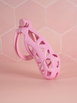 The Cobra Double Cuff Chastity Device in pink, the cage is shown here fully assembled.