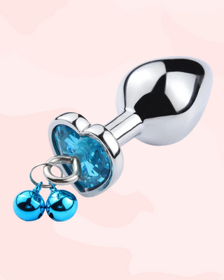 The blue butt plug is shown at an angle, you can see the matching colour bells and the loop that allows for lead attachment.