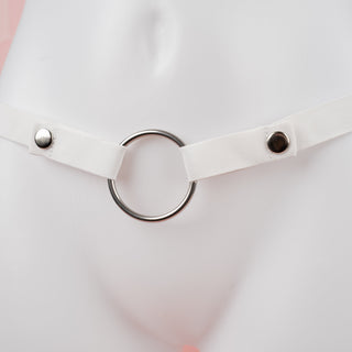A close up of the white chastity belt, you can see the poppers fixed in place.