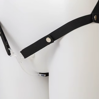An angled view of the transparent Femme Fantasy sissification cage, the curved cage design can be seen.