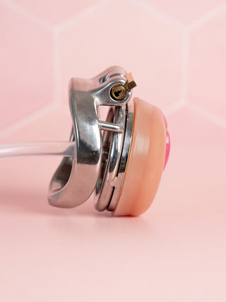A side view of the Flat Gatling chastity cage, the curved base ring is fitted to this cage.