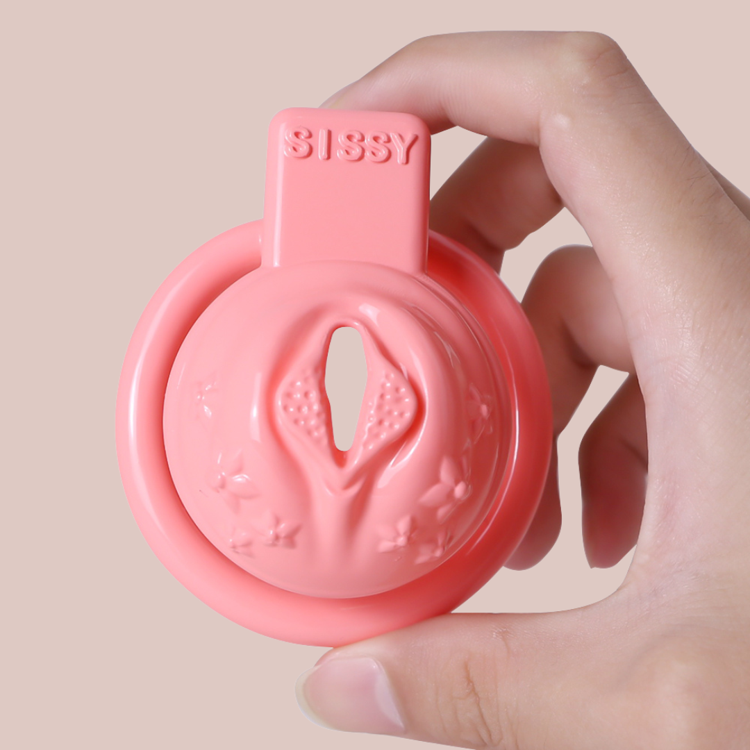 A view of the Flower Power Sissy Pussy chastity cage from House Of Chastity being held by a model to provide an idea of size.