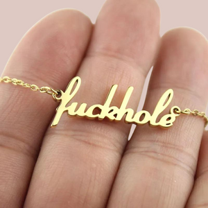 A close up of the fuckhole pendant, you can see the lowercase lettering.