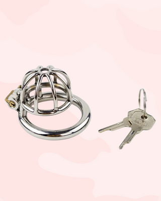 A stainless steel chastity cage in extra small size. The head is designed in an spaced, umbrella bar design and has a centre hole to allow a urethral tube to be attached if desired. The cage has one ring, that the cage attaches to and when joined, the integral lock can be fixed into place. It comes with one lock and 2 keys.