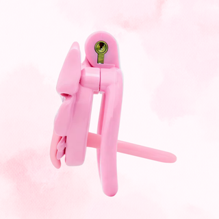 A side view of the pink chastity cage, it is shown fully assembled and with the urethral tube fitted