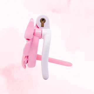 A side view of the pink and white chastity cage, it is shown fully assembled and with the urethral tube fitted