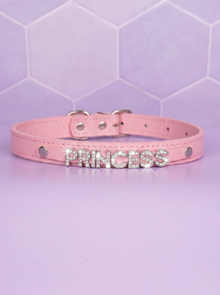 The Glimmer Princess Collar in pale pink on a purple background