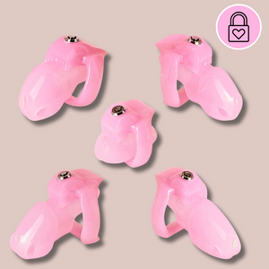 Showing the full set of HT V5 Pink Chastity Cages, shown are the Nub, Small, Nub, Standard and Maxi chastity devices.