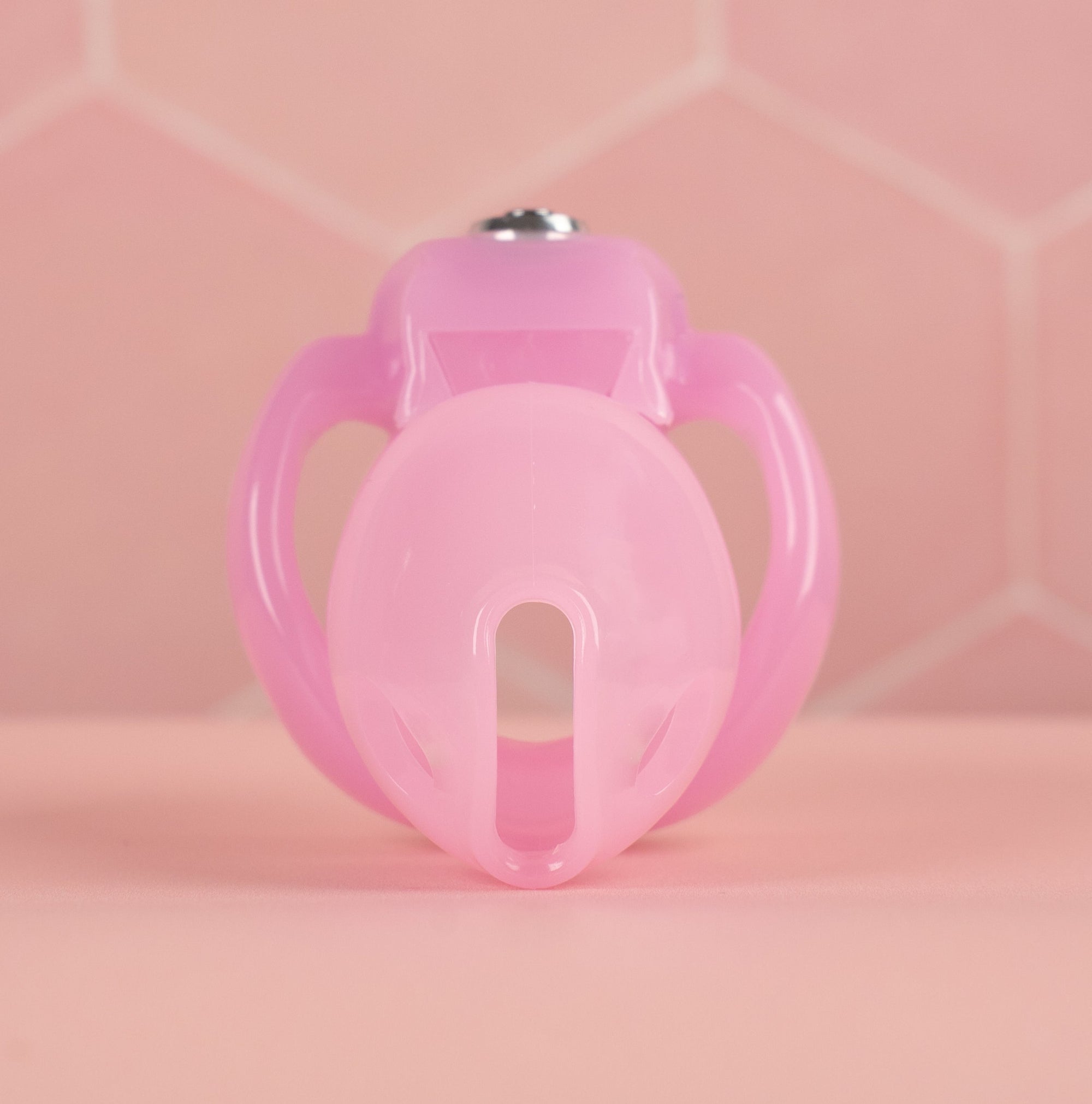  A front facing view of the HT V5 Nano chastity cage, it is shown here in pink.