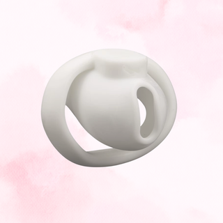 A front view of the fully assembled chastity cage on a pink background