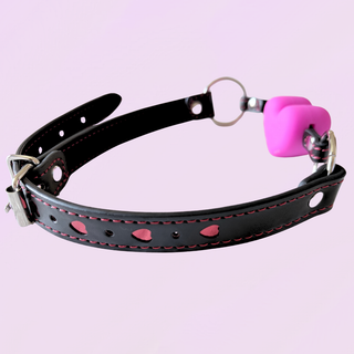 A close up of the black strap with red heart detailing 