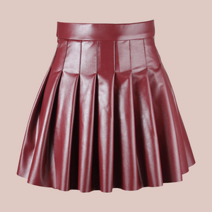 A close up front view of the burgundy PU Leather pleated mini skirt you can see just how soft and shiny the material is.