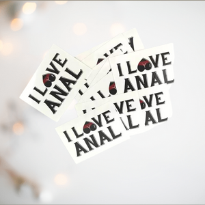 Shown here is a pile of I Love Anal temporary tattoos.