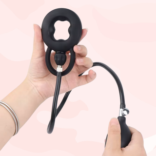 The inflatable cock ring is shown being held.