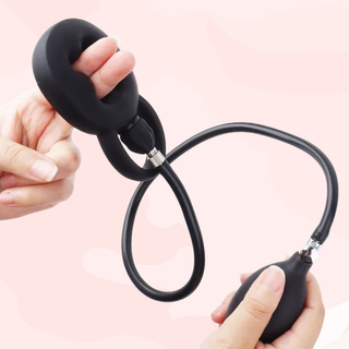 The Cock Ring Pump shown being held, the fingers indicate where the penis is inserted.