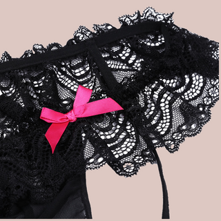 Close up of low rise hip style knickers with deep lace skirt, penis pouch and two decorative pink bows.
