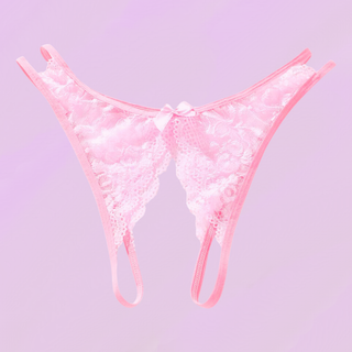 the pink crotchless panties lying on a soft purple background