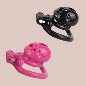 The Locked Life Chastity Cages from House Of Chastity, they are shown here in black and pink, with the word SLAVE imprinted on the top.