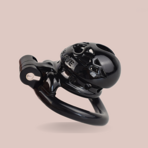 The black Locked In Love chastity cage from House of Chastity, it is shown here fully assembled and with the word Slave imprinted on it.